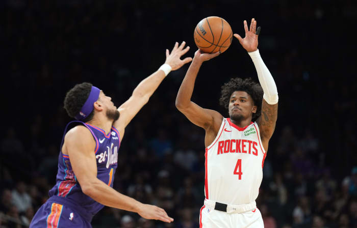Rockets guard Jalen Green (4) shoots over Phoenix Suns guard Devin Booker (1) during the first half at Footprint Center.